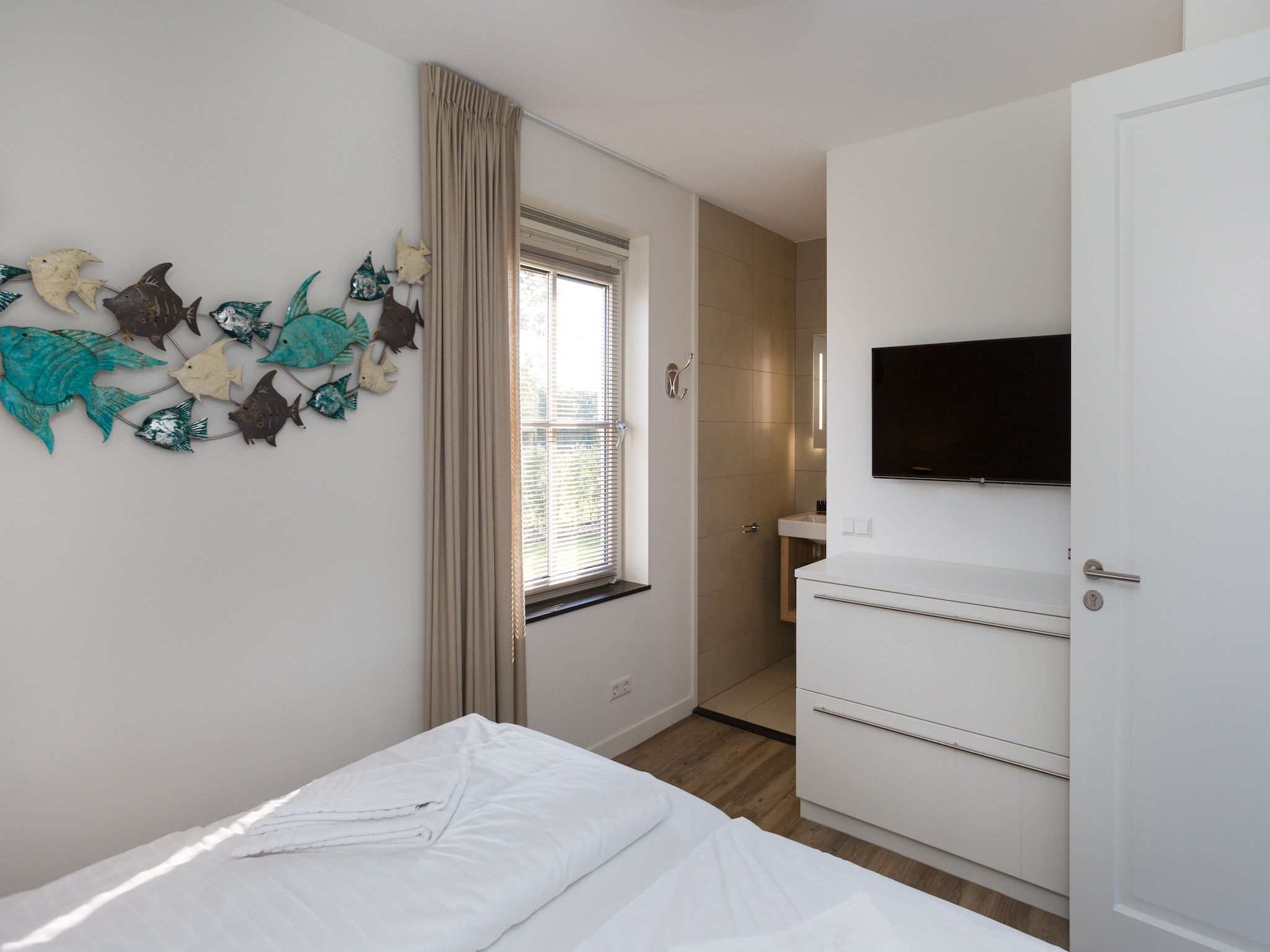 Een slaapkamer van Friese Meren Villa's 14 in Delfstrahuizen