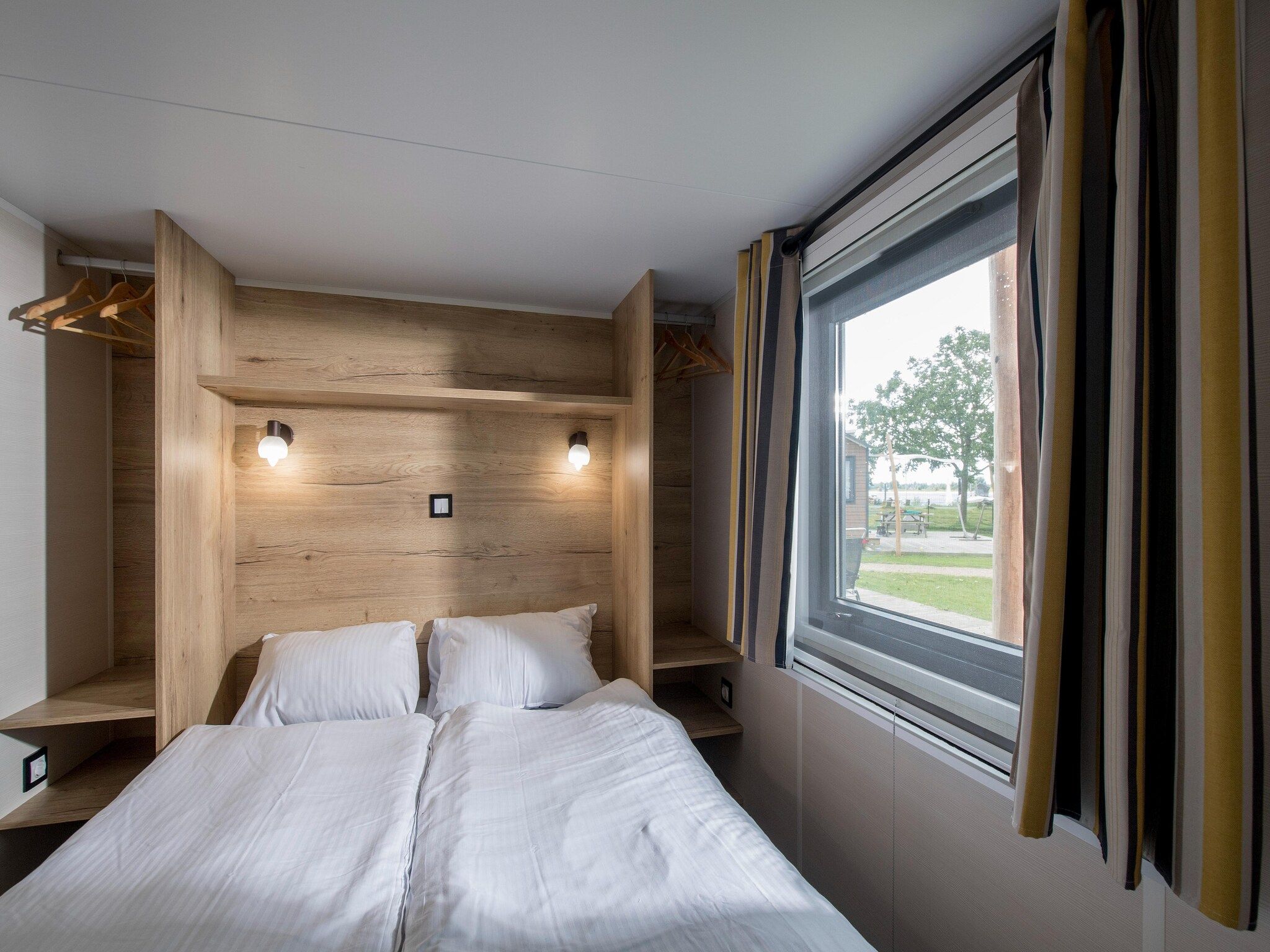 Een slaapkamer van Vakantiepark Eiland van Maurik 9 in Maurik