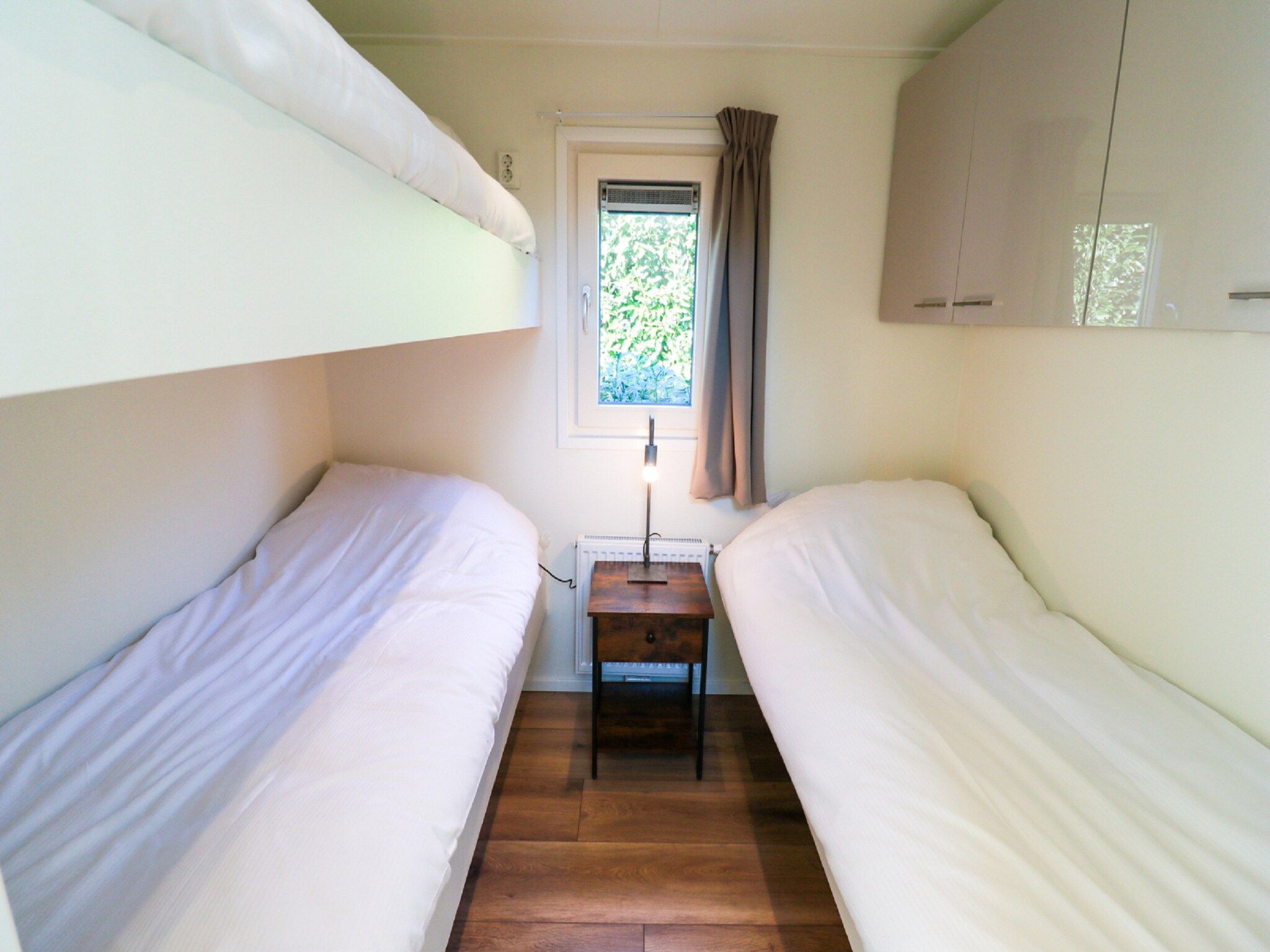 Een slaapkamer van Vakantiepark De Rimboe & De Woeste Hoogte 13 in Hoenderloo