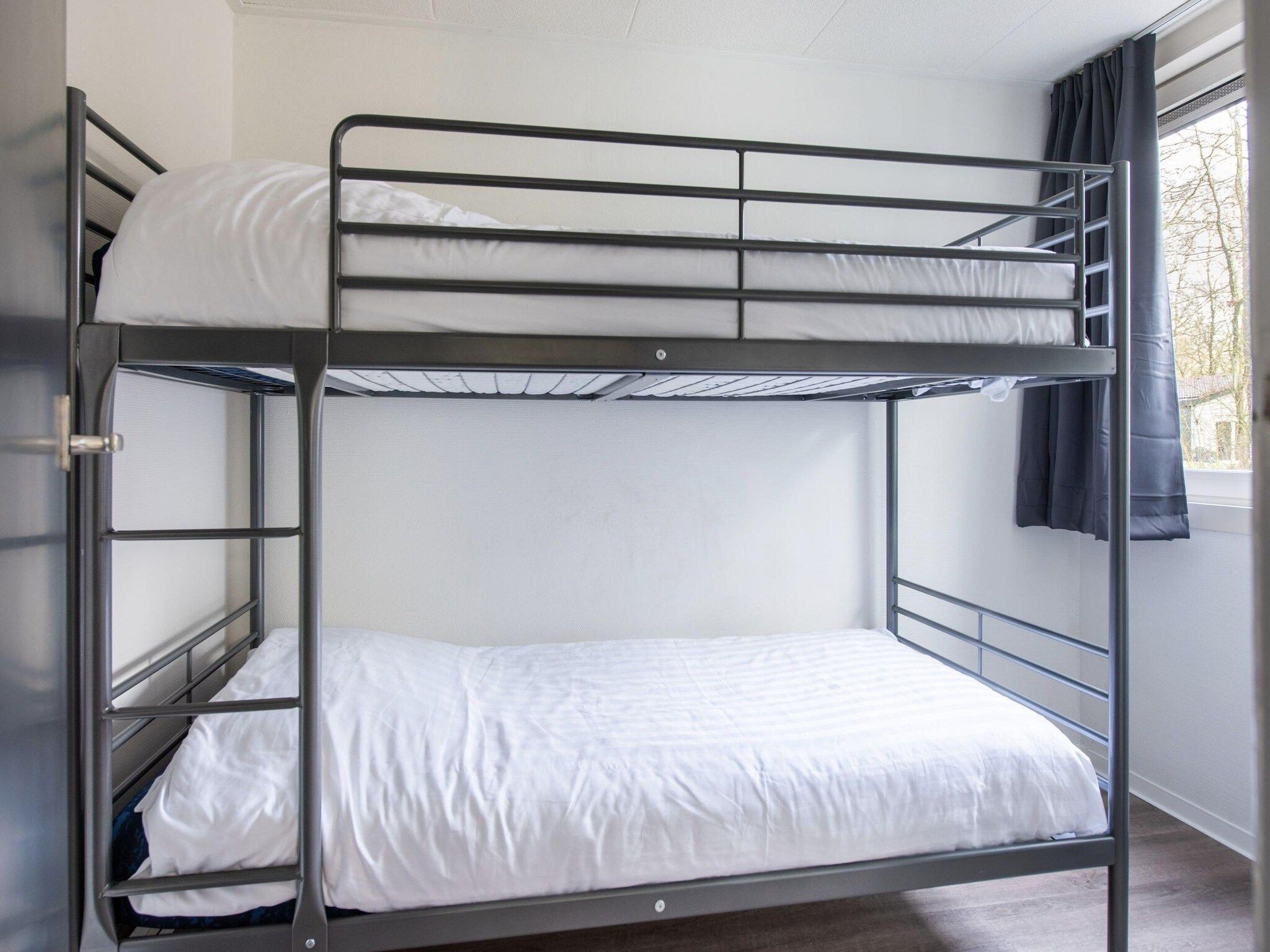 Een slaapkamer van Vakantiepark de Berkenhorst 11 in Kootwijk