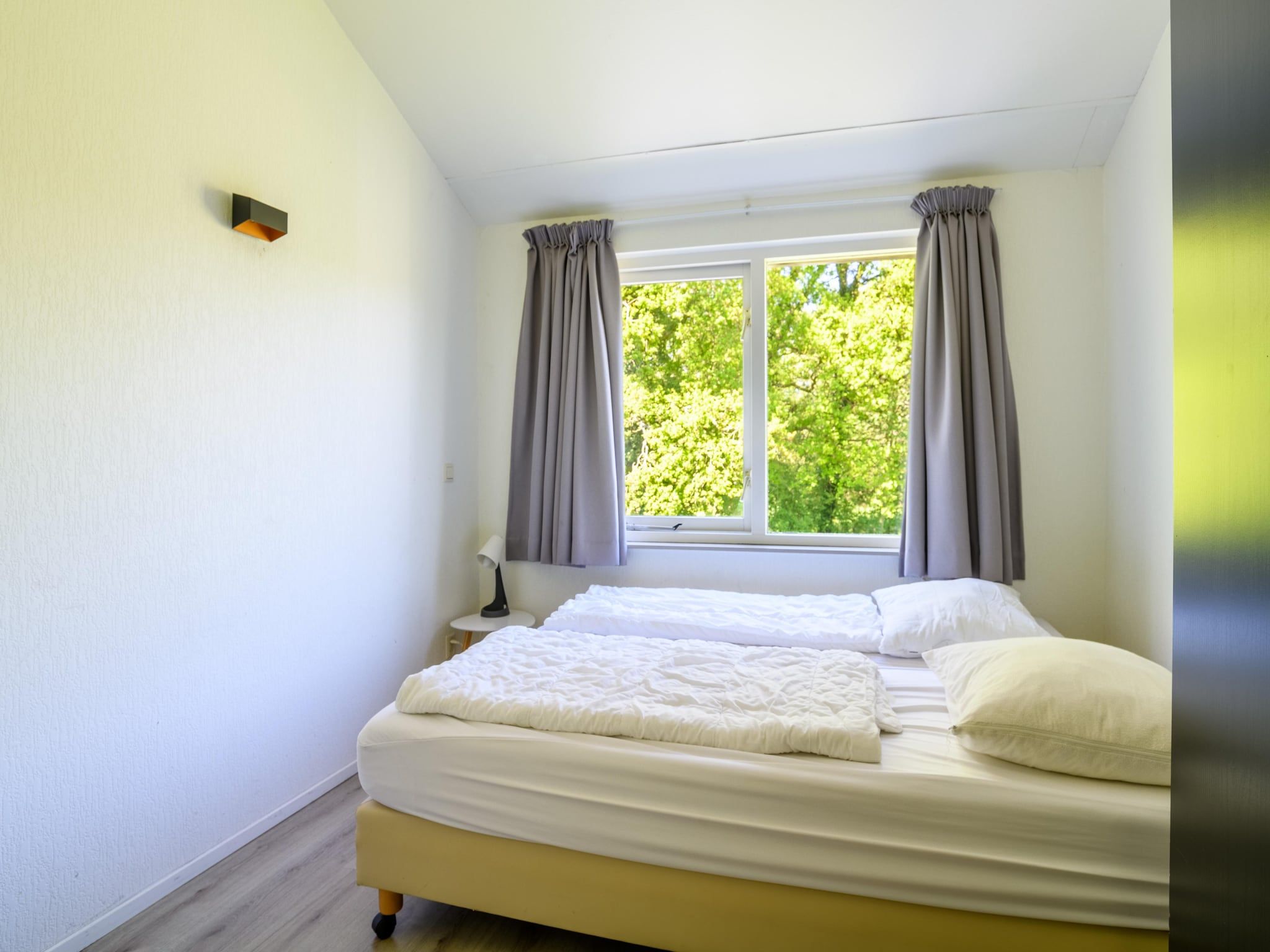 Een slaapkamer van Vakantiepark Emslandermeer 13 in Vlagtwedde