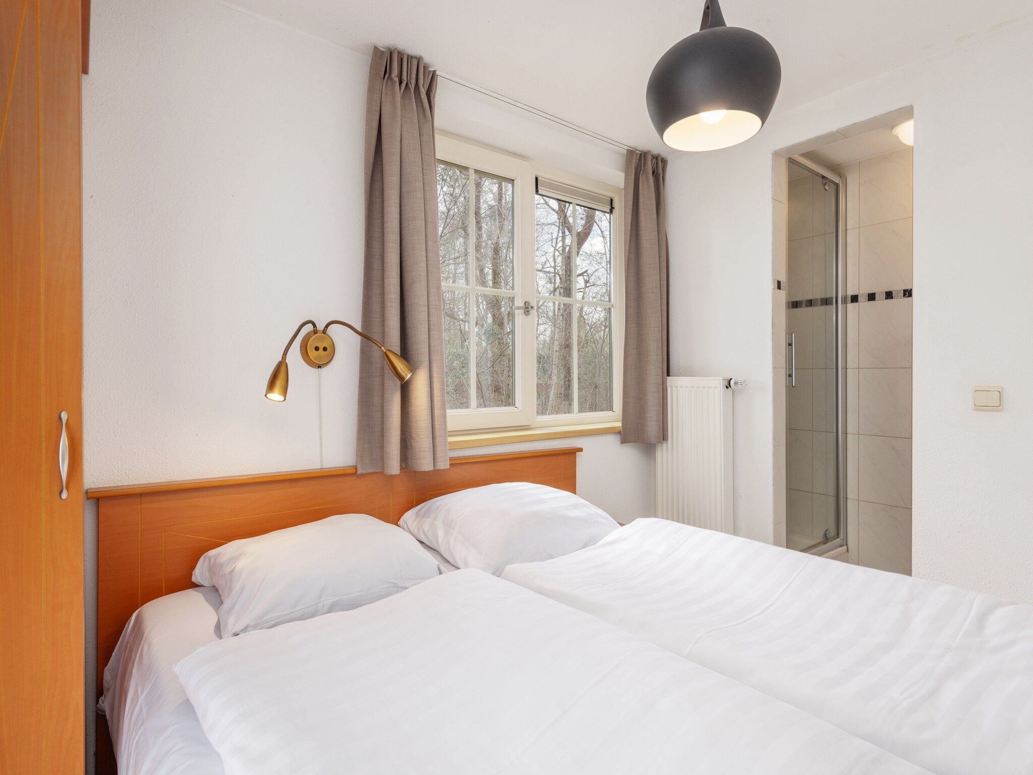 Een slaapkamer van De Veluwse Hoevegaerde 2 in Putten