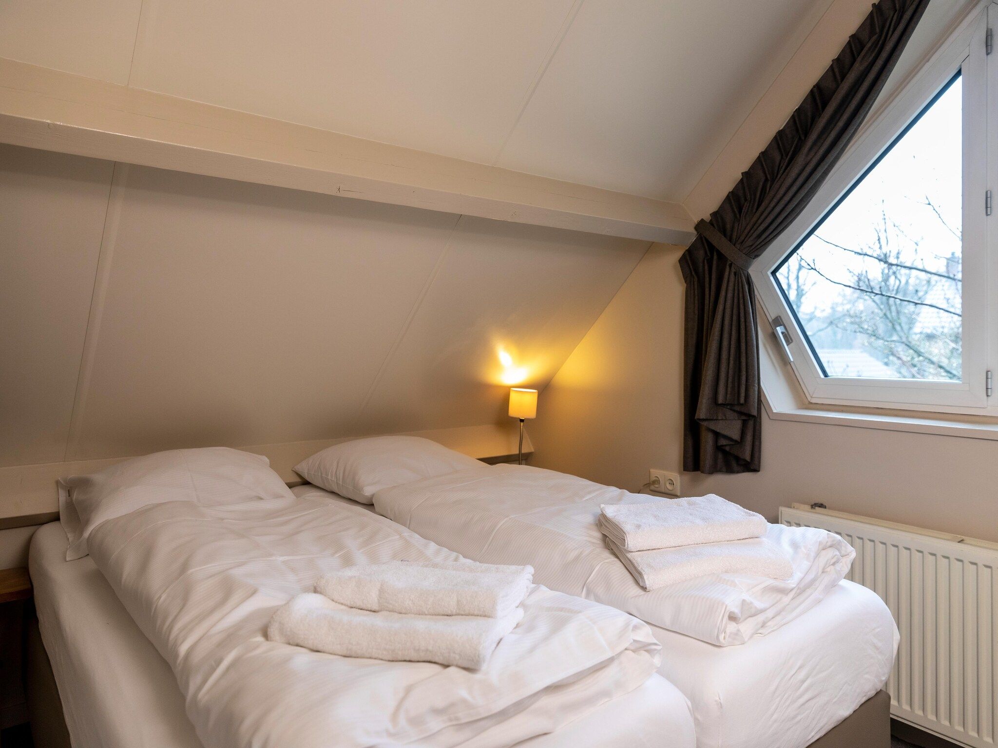 Een slaapkamer van Vakantie bij Meeussen - Schuttersoord 2 in Mook