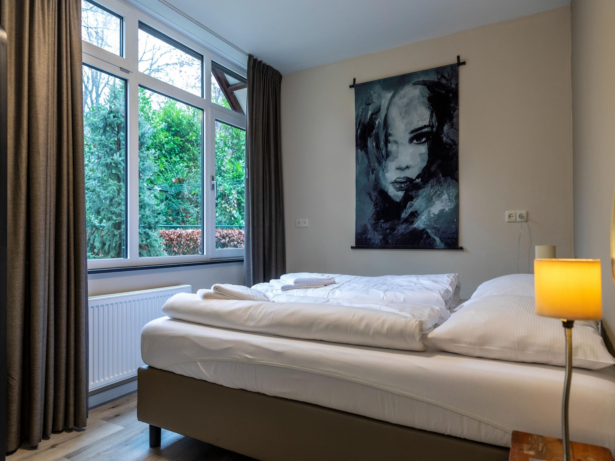 Een slaapkamer van Vakantie bij Meeussen - Schuttersoord 2 in Mook