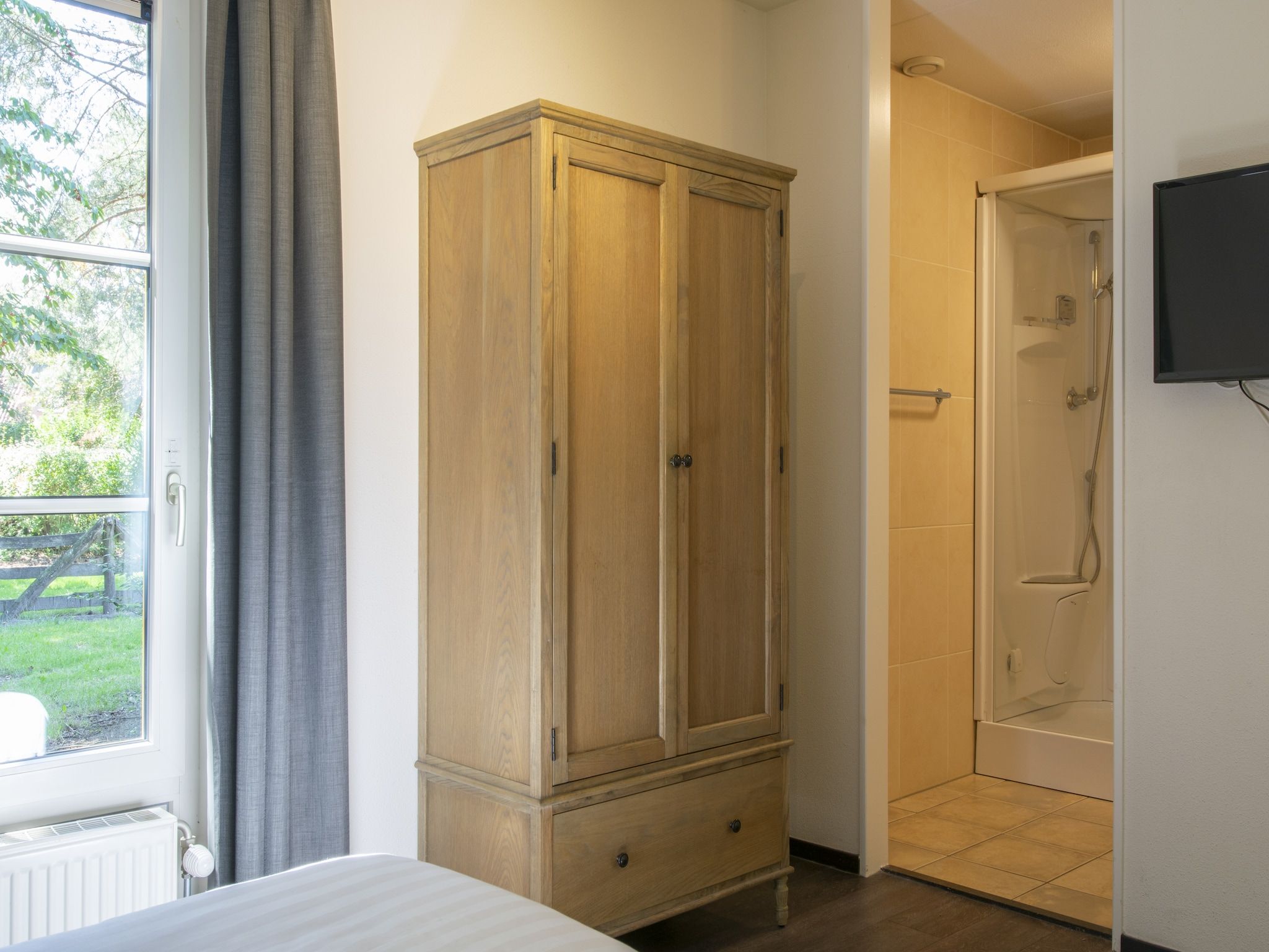 Een slaapkamer van Vakantiepark de Katjeskelder 16 in Oosterhout