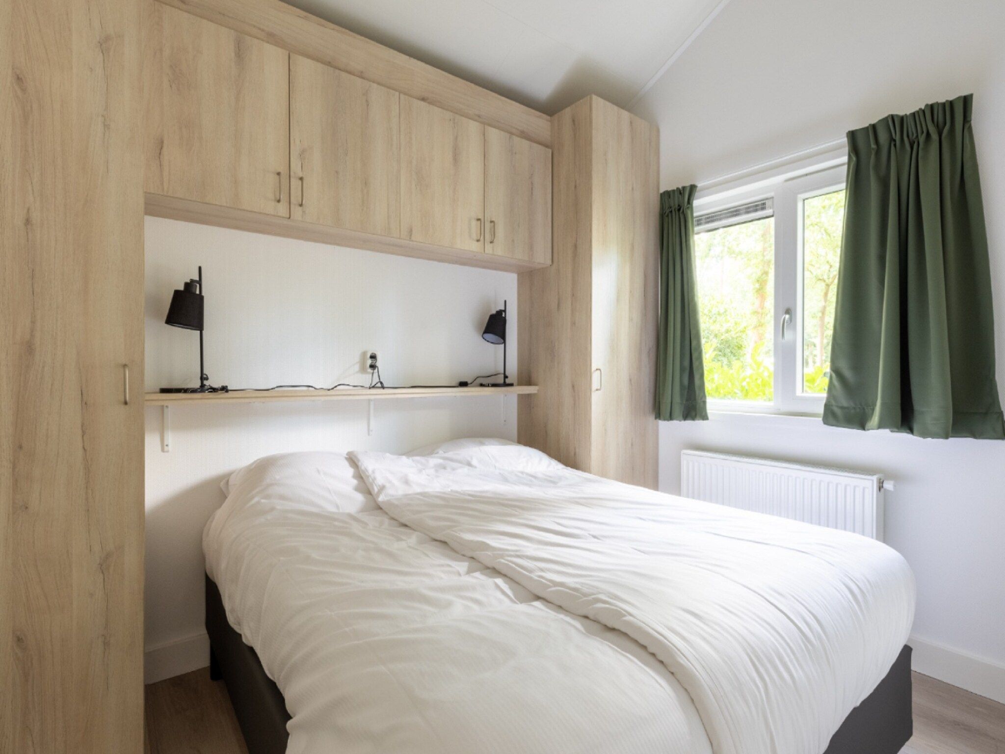 Een slaapkamer van Vakantiepark De Rimboe & De Woeste Hoogte 21 in Hoenderloo