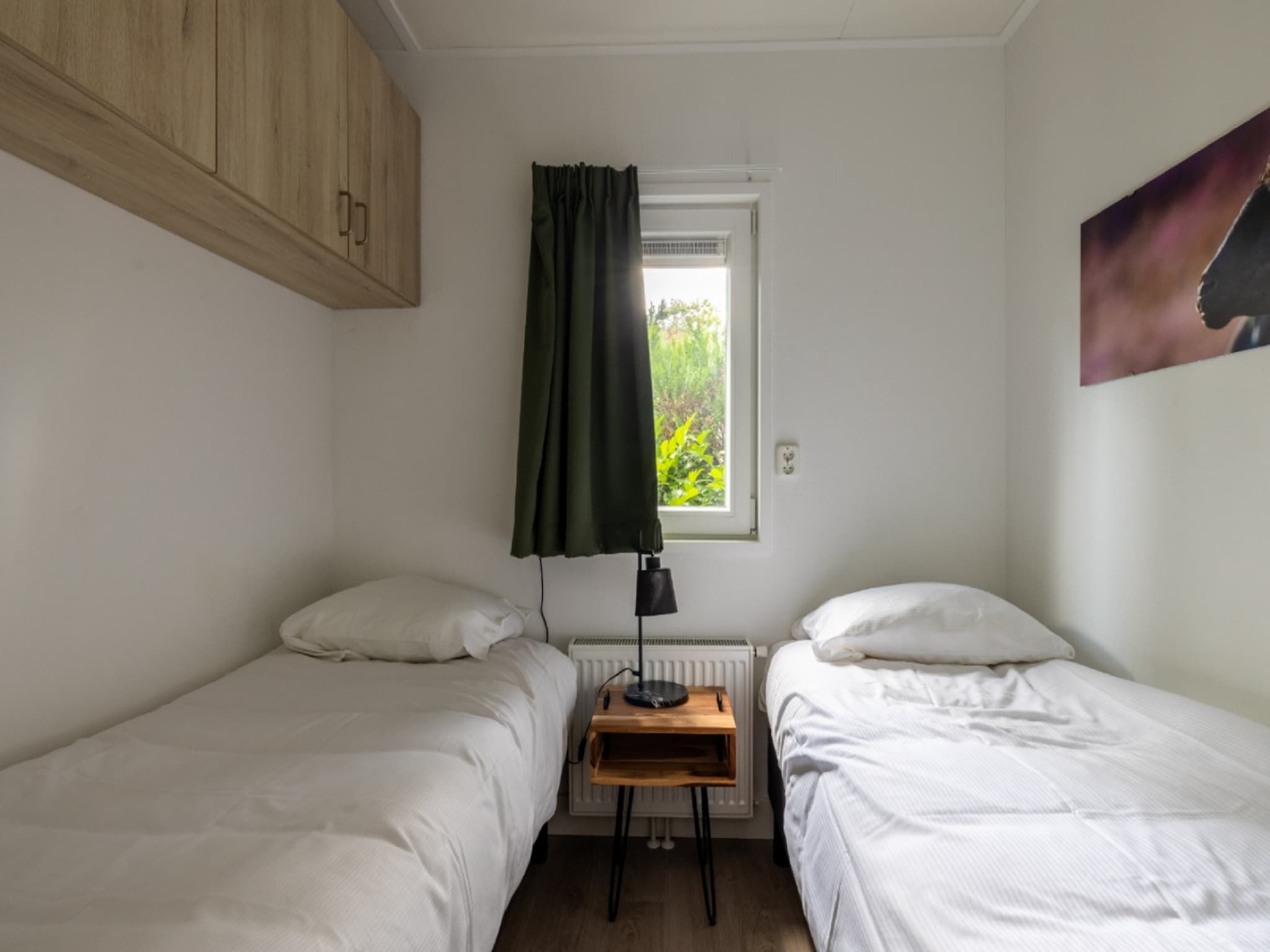 Een slaapkamer van Vakantiepark De Rimboe & De Woeste Hoogte 21 in Hoenderloo