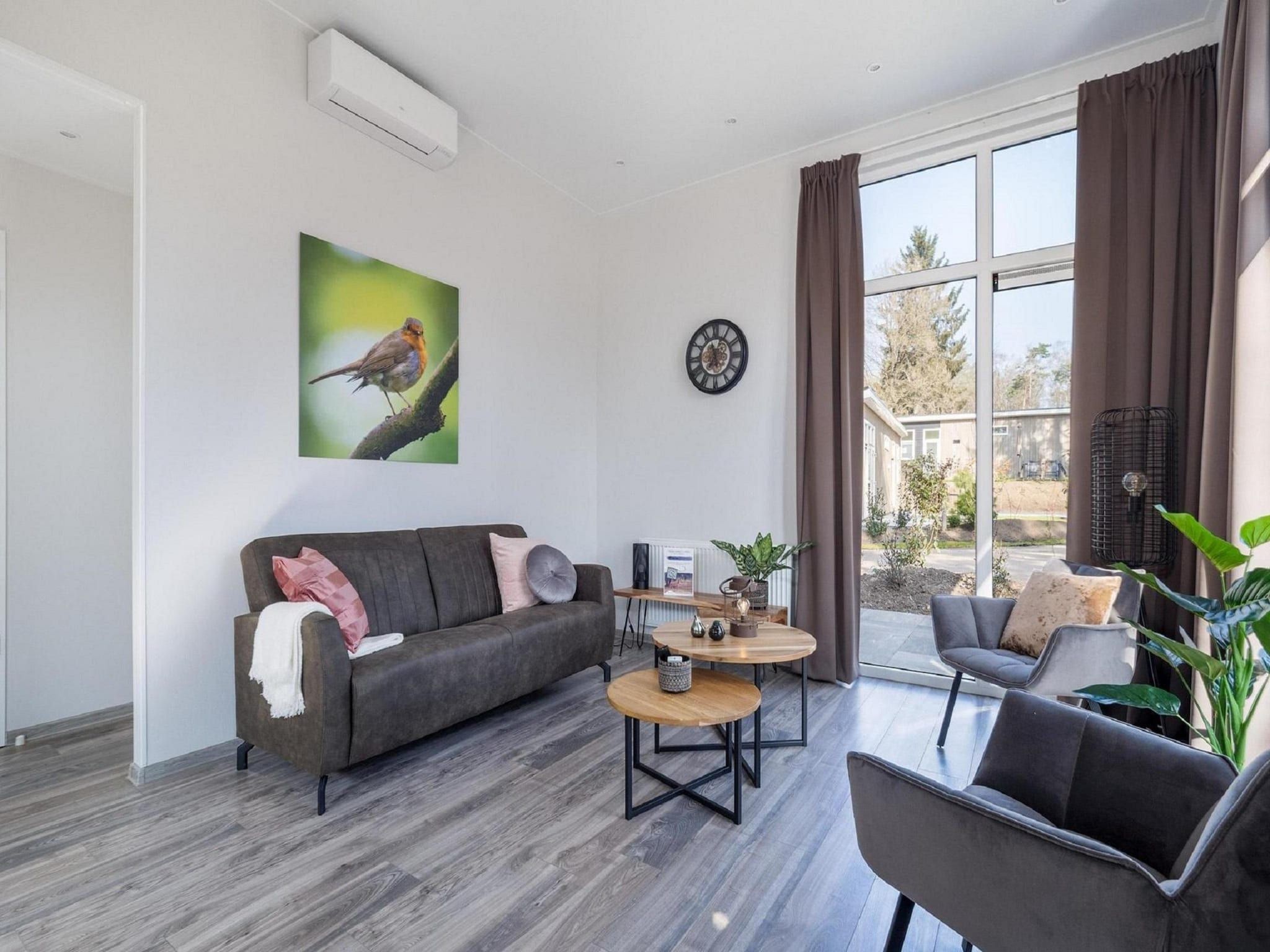 De woonkamer van Vakantiepark De Rimboe & De Woeste Hoogte 24 in Hoenderloo