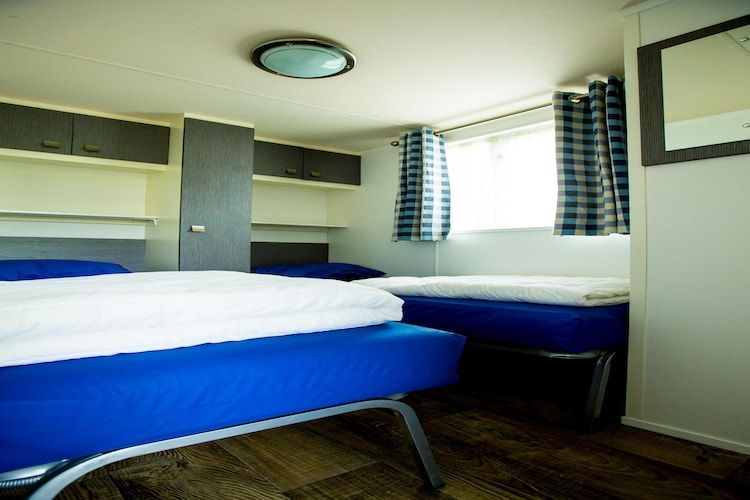 Een slaapkamer van Recreatiepark Duinhoeve 10 in Udenhout