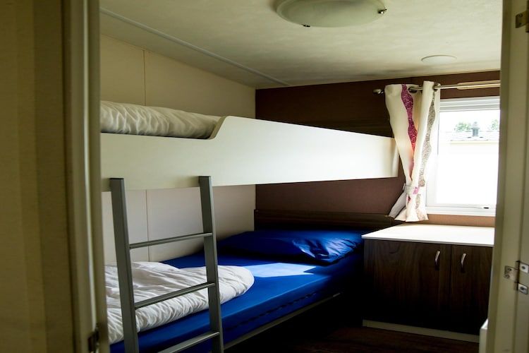 Een slaapkamer van Recreatiepark Duinhoeve 11 in Udenhout