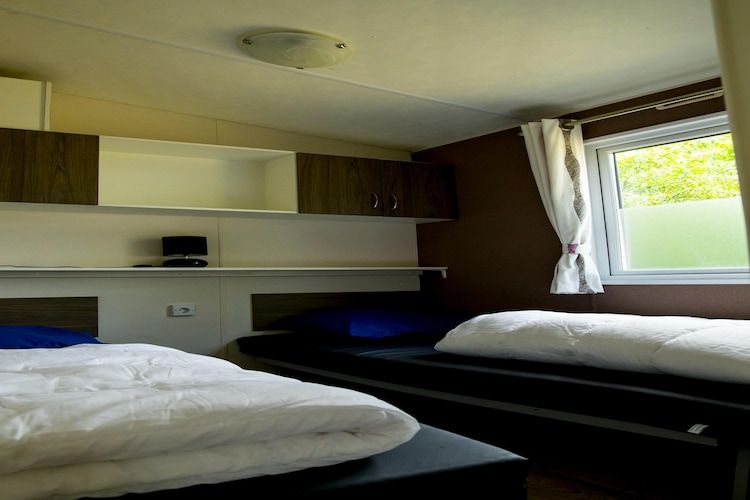 Een slaapkamer van Recreatiepark Duinhoeve 11 in Udenhout