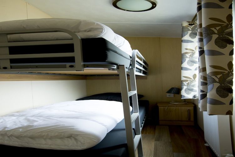 Een slaapkamer van Recreatiepark Duinhoeve 13 in Udenhout