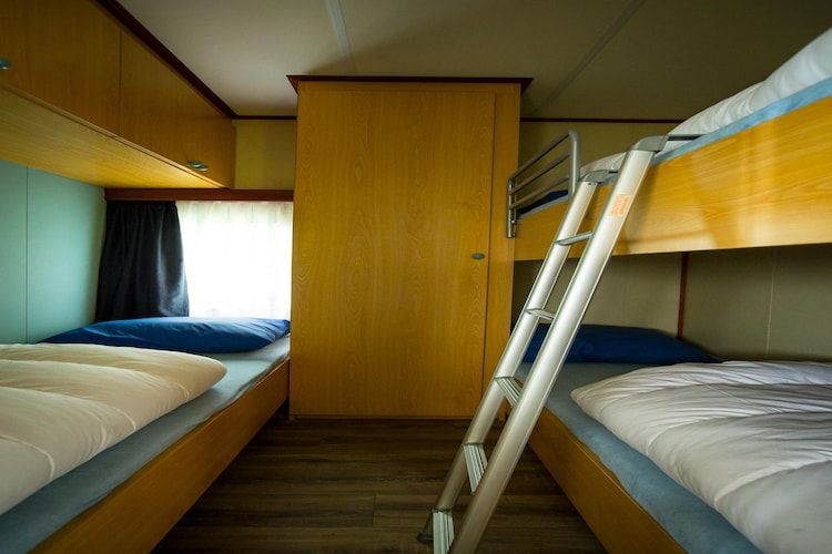 Een slaapkamer van Recreatiepark Duinhoeve 3 in Udenhout