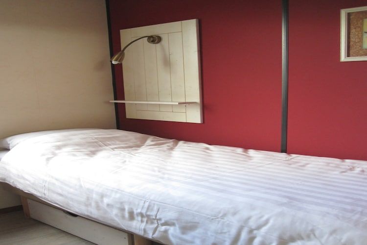 Een slaapkamer van Strandpark Vlugtenburg 5 in 's-Gravenzande